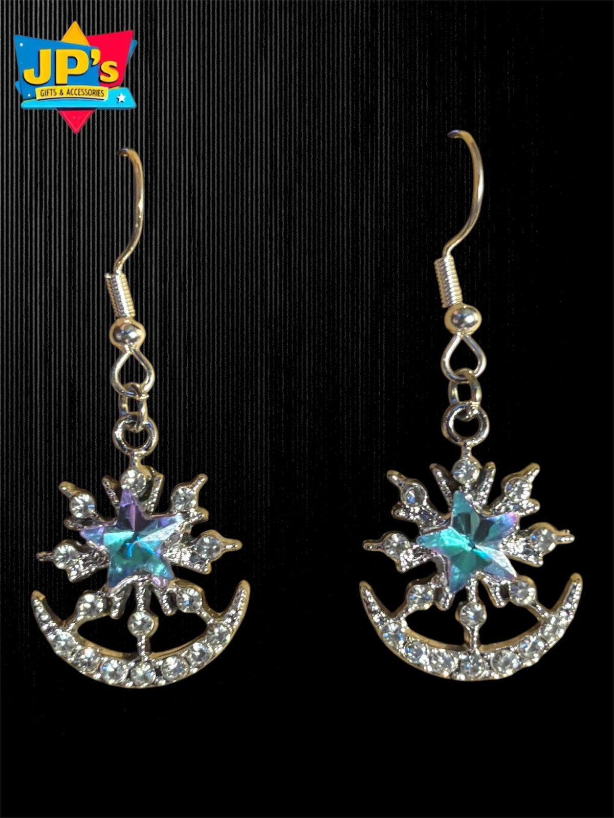 Pair of silver plated star and crescent moon earrings with turquoise center stones and rhinestone details on hooks.