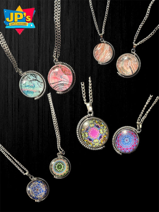 Collection of seven spinning patterned pendant necklaces with colorful mandala designs in silver metal frames on chains.