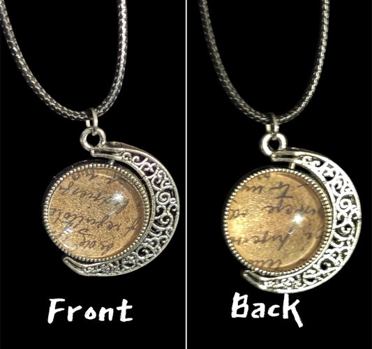 Front and back views of a silver ornamental pendant with spinning gold coin insert on braided chain.