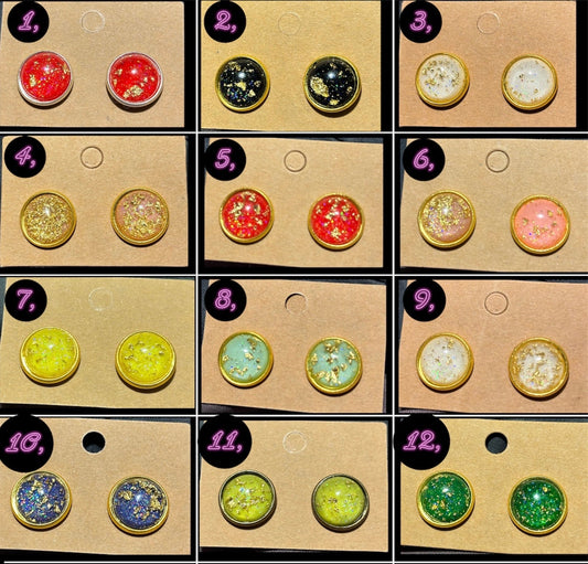 Twelve pairs of colorful stud earrings featuring resin domes with embedded gold flakes in various colors including red, black, white, pink, yellow, green, and blue.