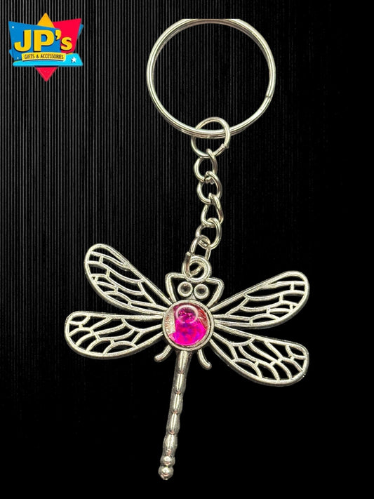 Silver dragonfly keychain with pink glass dome center, detailed wing patterns, attached to chain and ring.